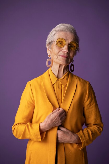 An old woman wearing fashionable yellow clothing.