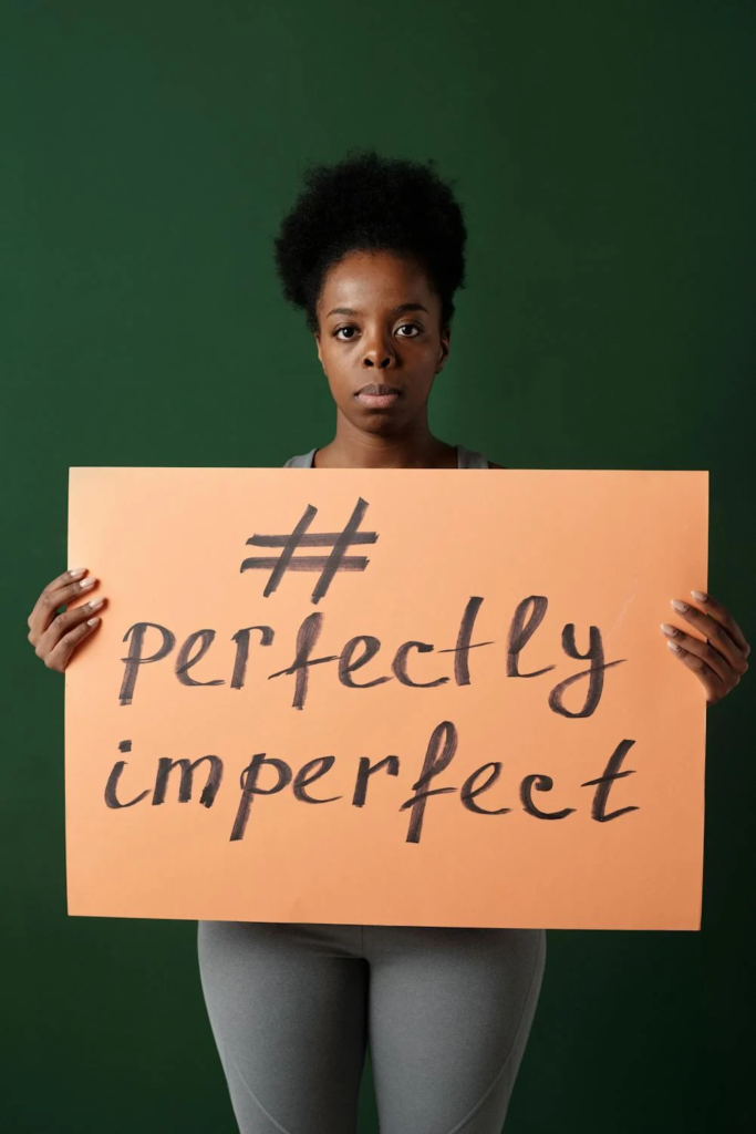 Woman Holding a Placard With Motivational Hashtag #perfectlyimperfect