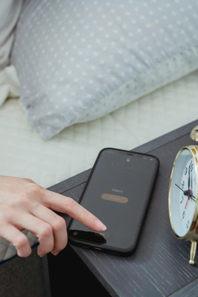 Woman snoozing alarm on smartphone
