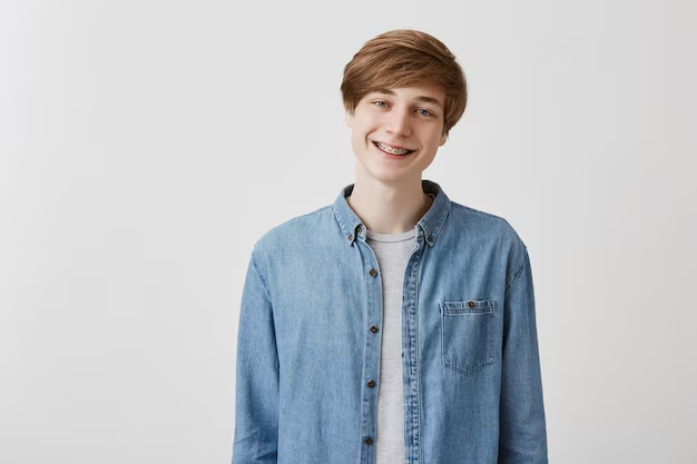 Young boy wearing a denim shirt and smiling