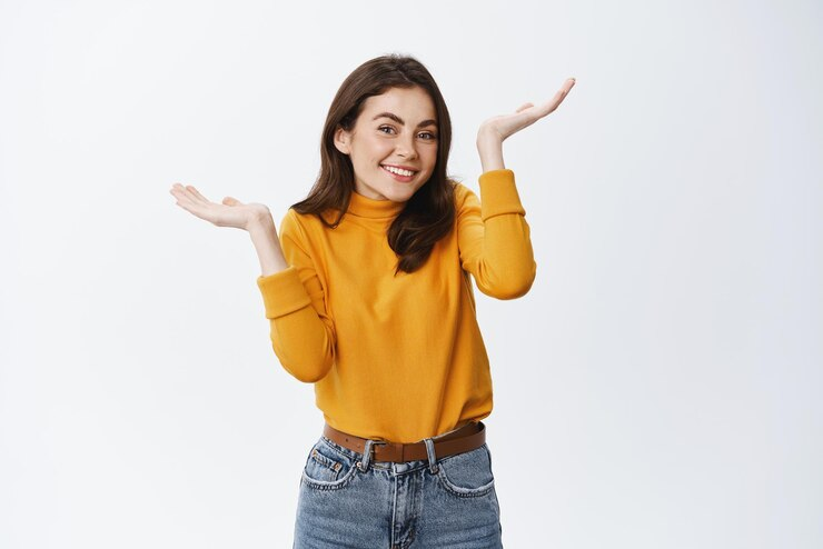 Woman standing with her hands pointing upwards