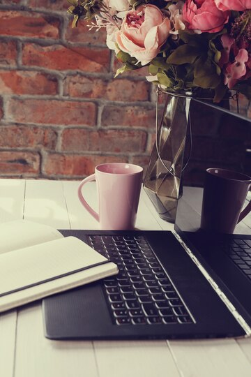 office space with a laptop and beautiful flowers